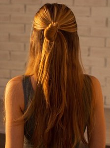 Honey blonde woman with a half-up hairstyle with long layers